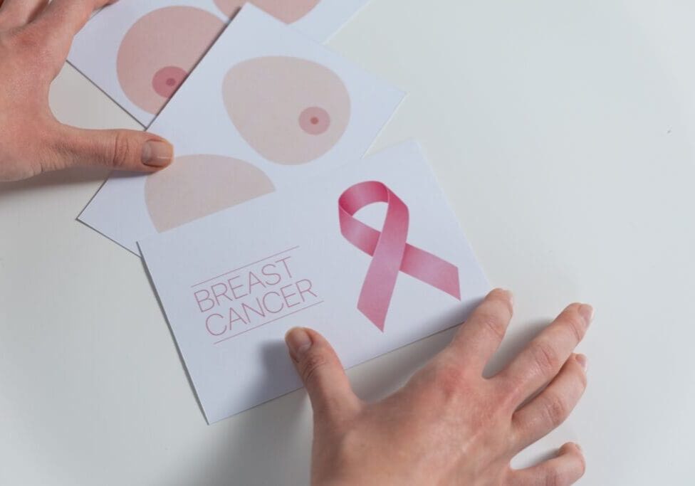 A person is holding up an image of breast cancer.
